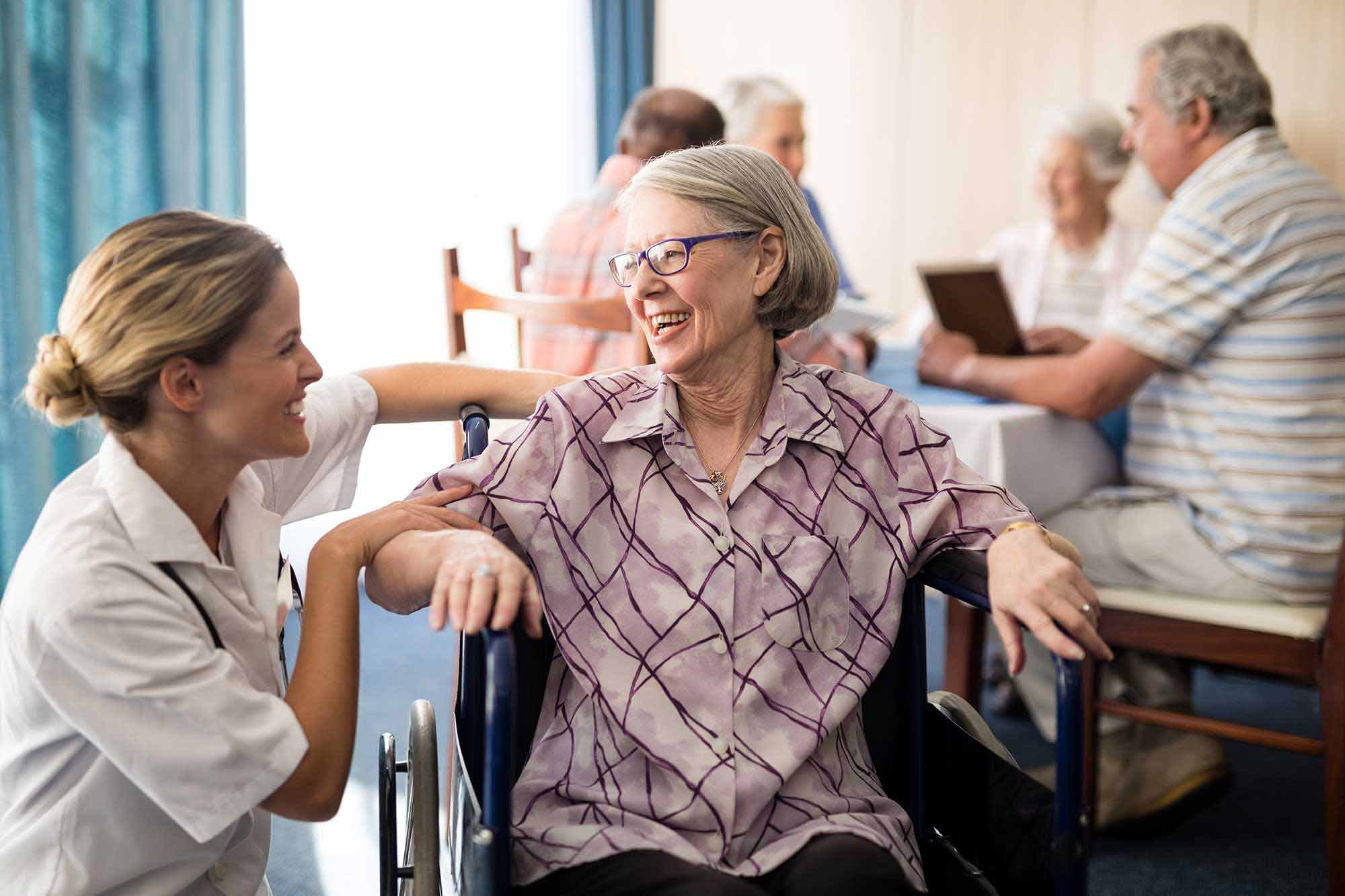 Nurse helping elderly lady