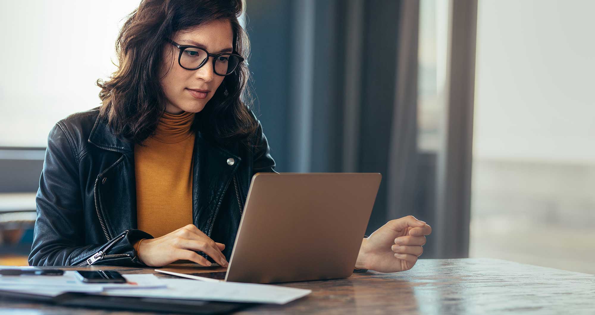 Woman checks cybersecurity status on computer