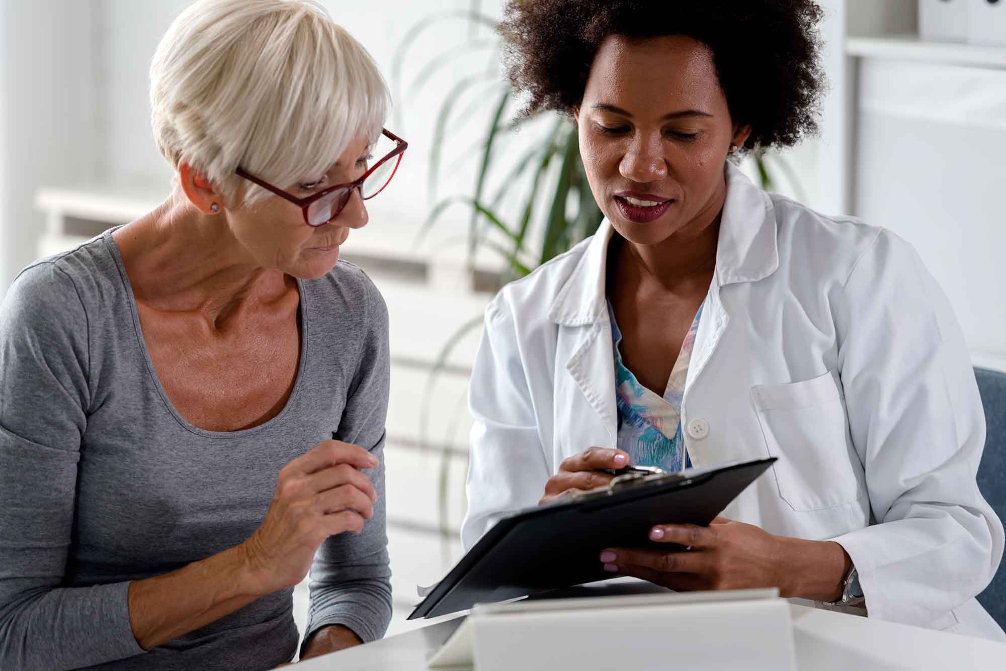 Woman talking with medical professional.