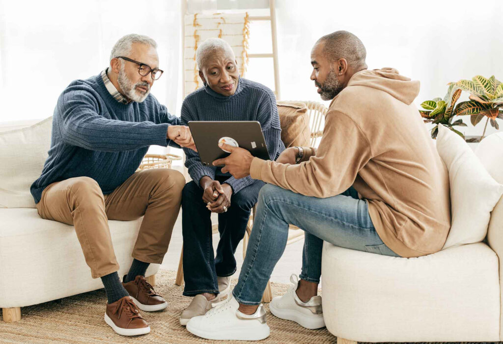 Son sitting with his parents looking for paperwork