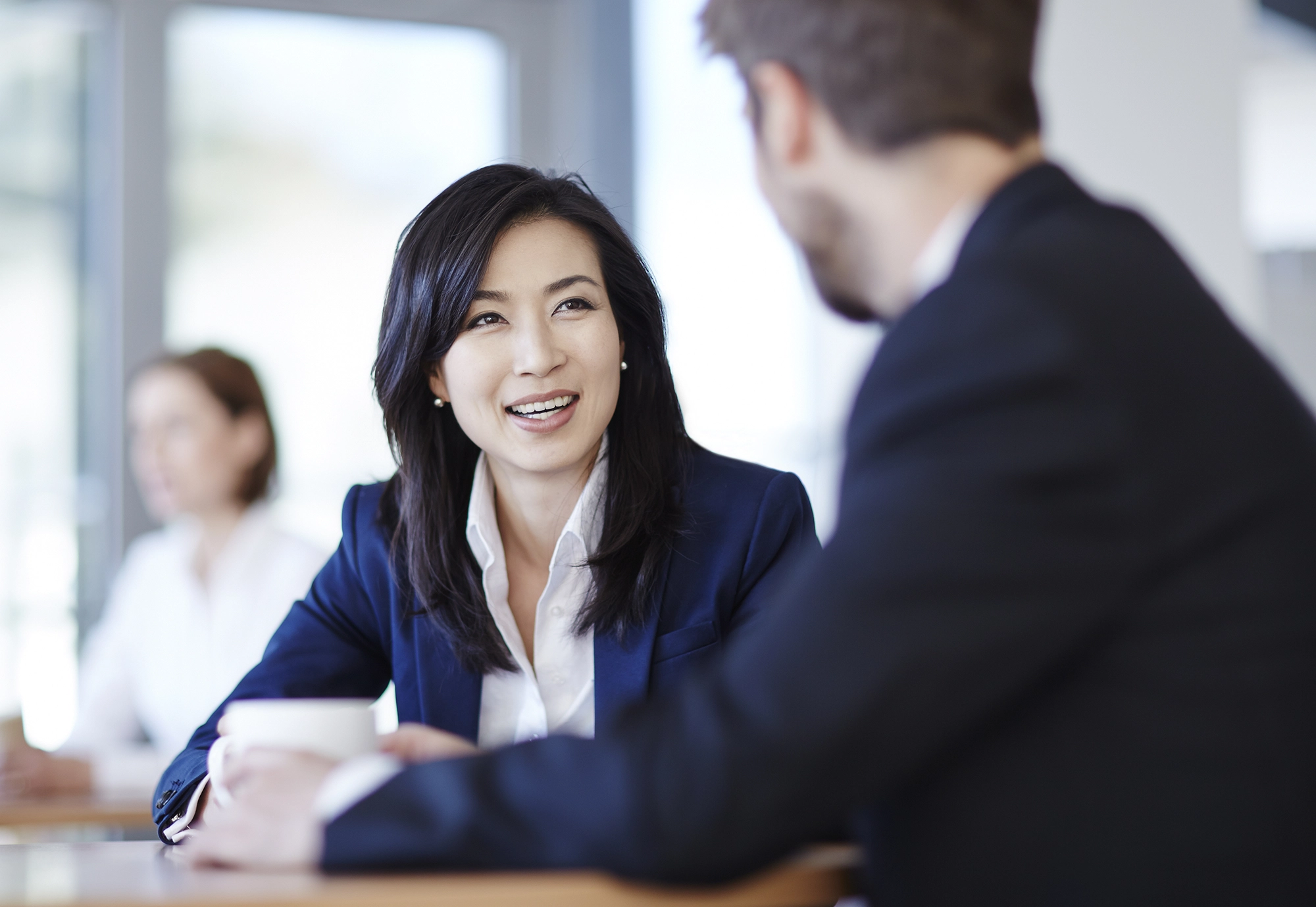 Woman talking to man at desk