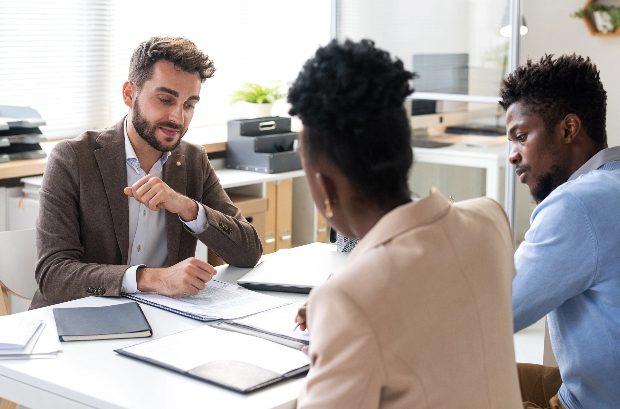 Couple at desk talking to tax advisor