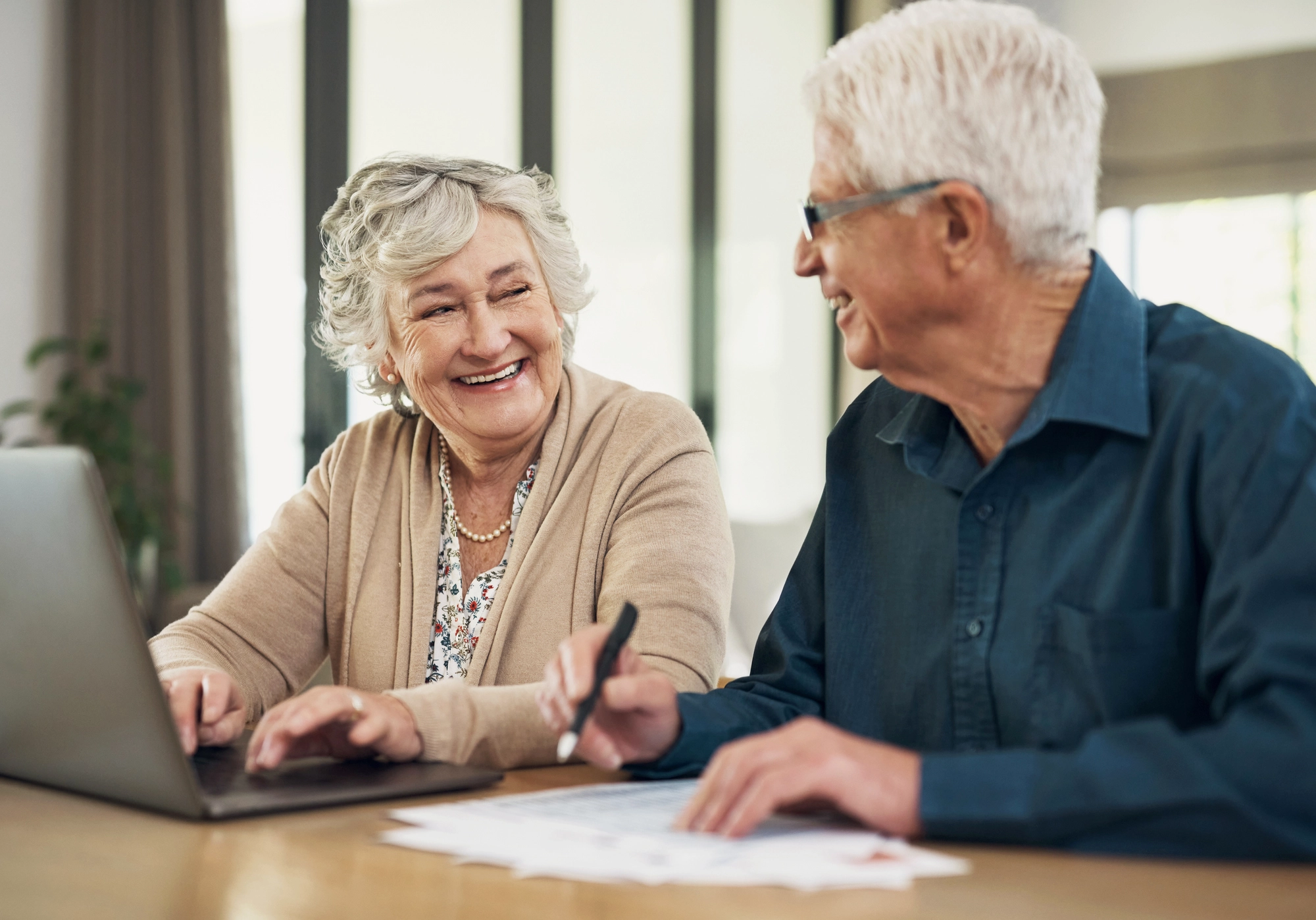 Senior couple in front of laptop