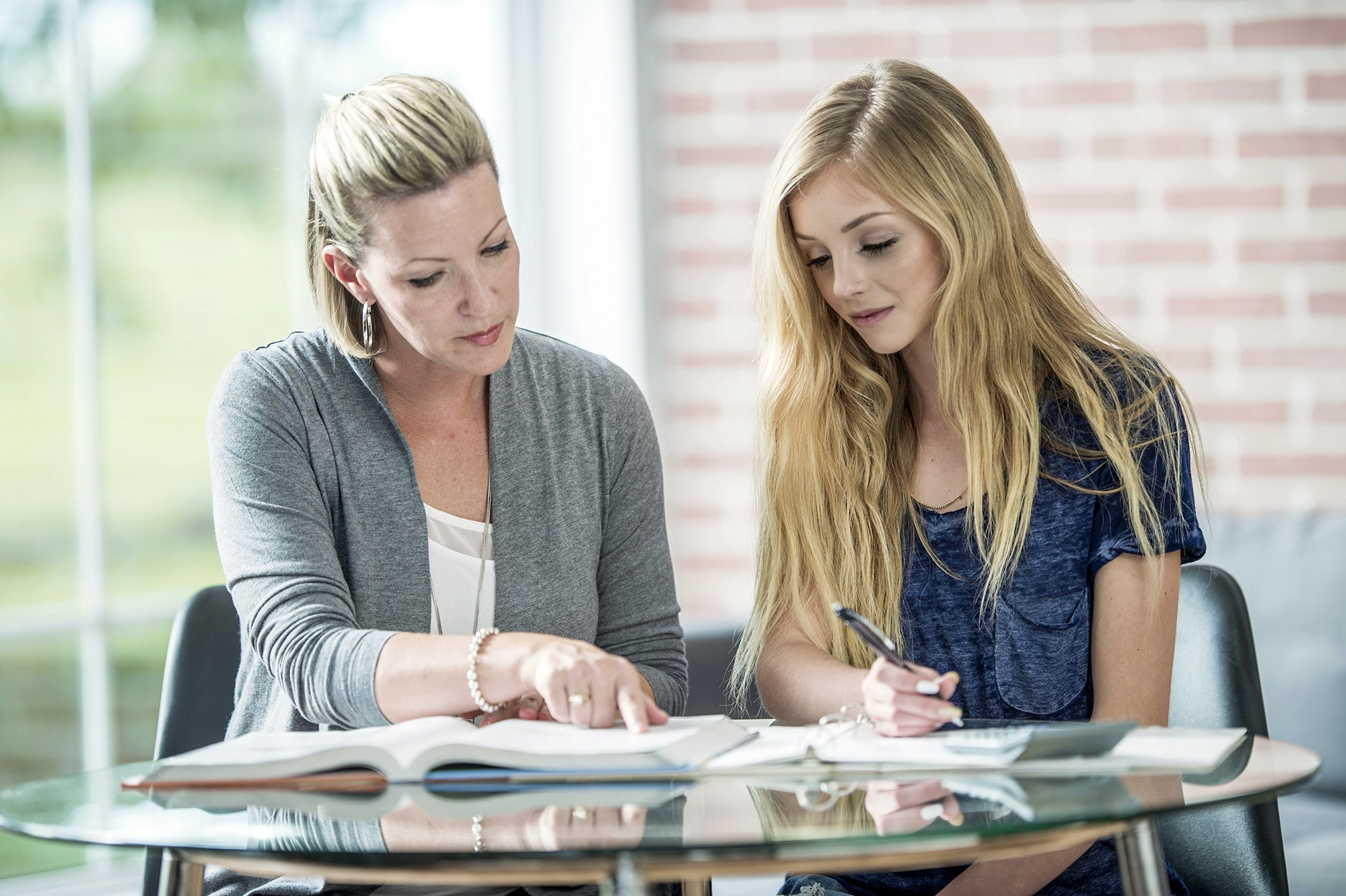 Mother and daughter looking at papers.