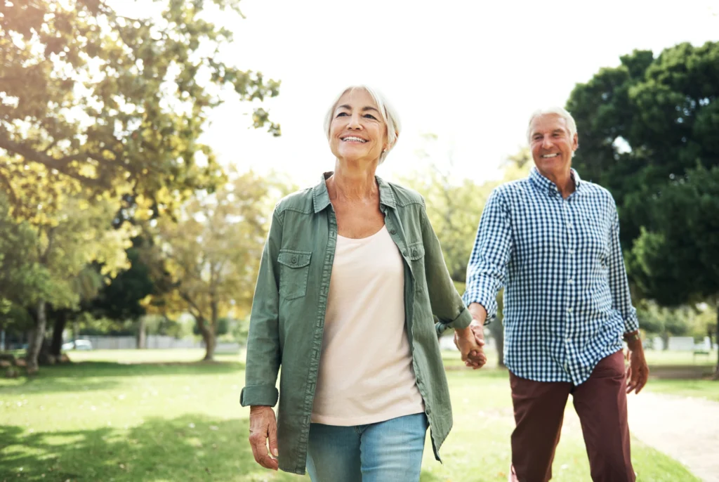 Senior couple holding hands and walking