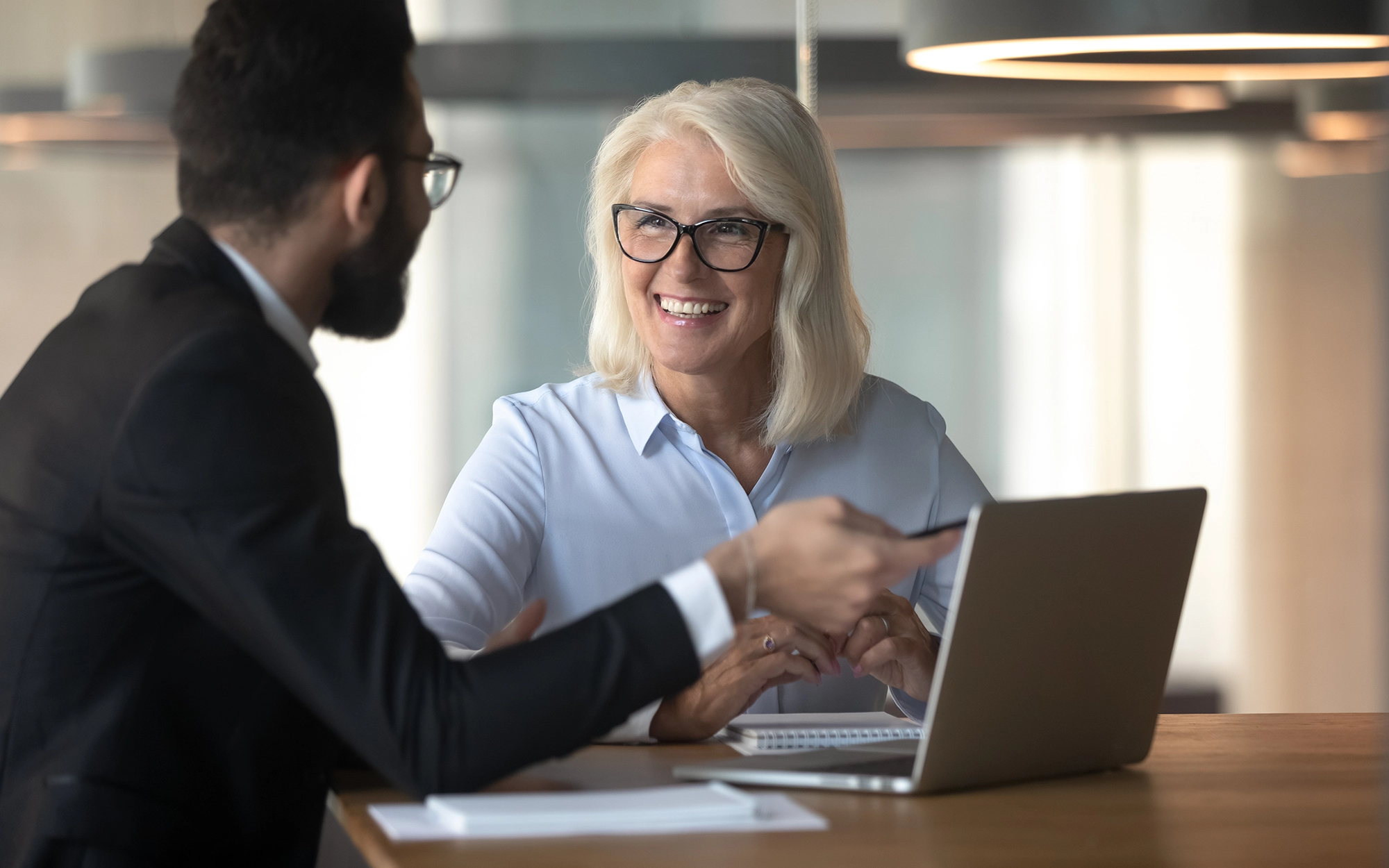 Senior woman shaking hands with advisor