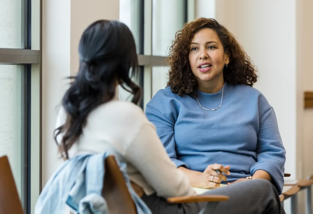 Two women speaking to each other