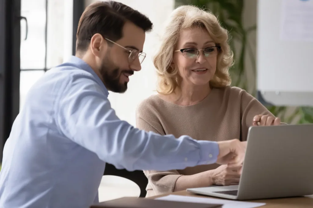 Advisor with client in front of computer