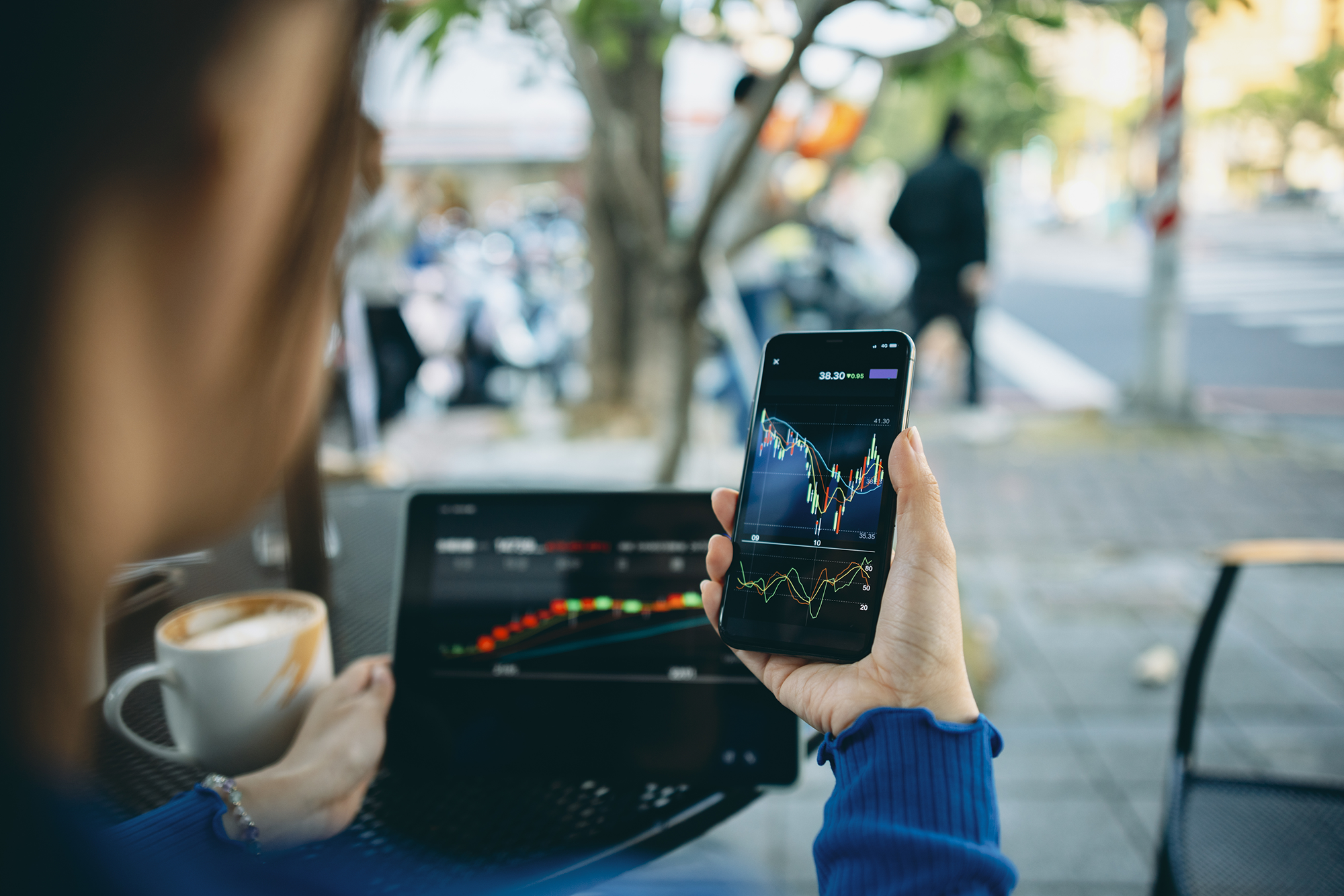 Person looking at stocks on his phone.