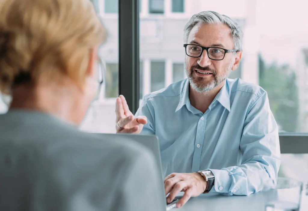 Senior man with glasses talking with a woman