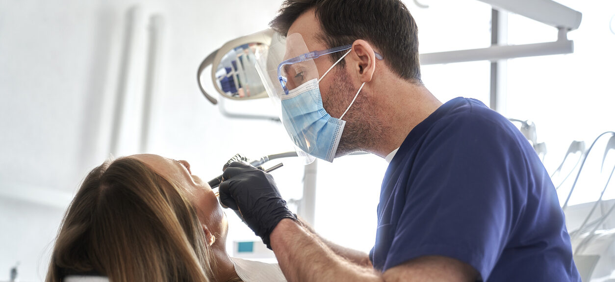 Dentist drilling in teeth of the patient
