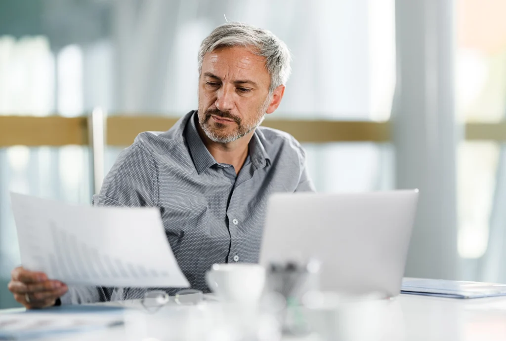 man looking at financial paperwork