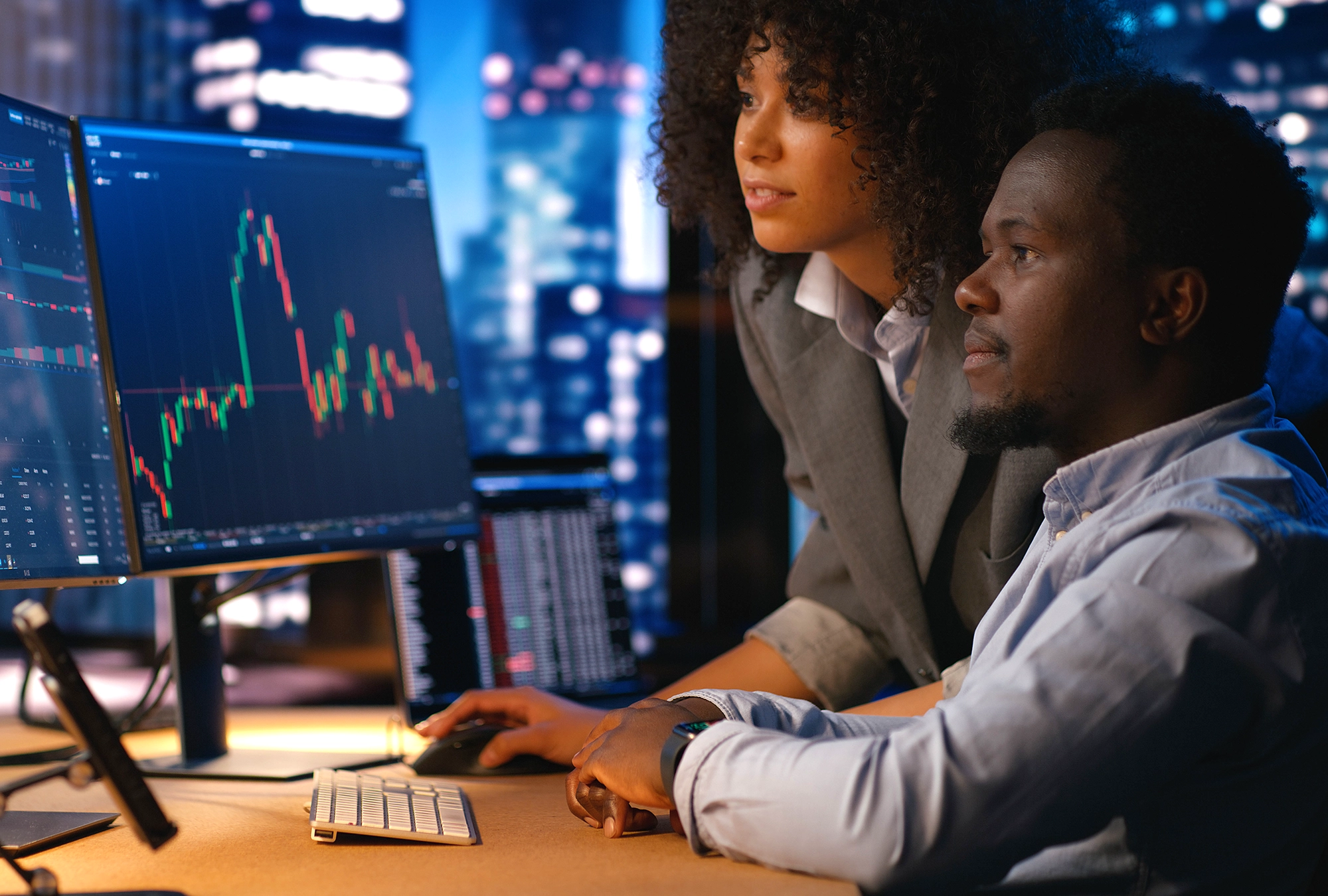 business owners looking at market data and trends on the computer