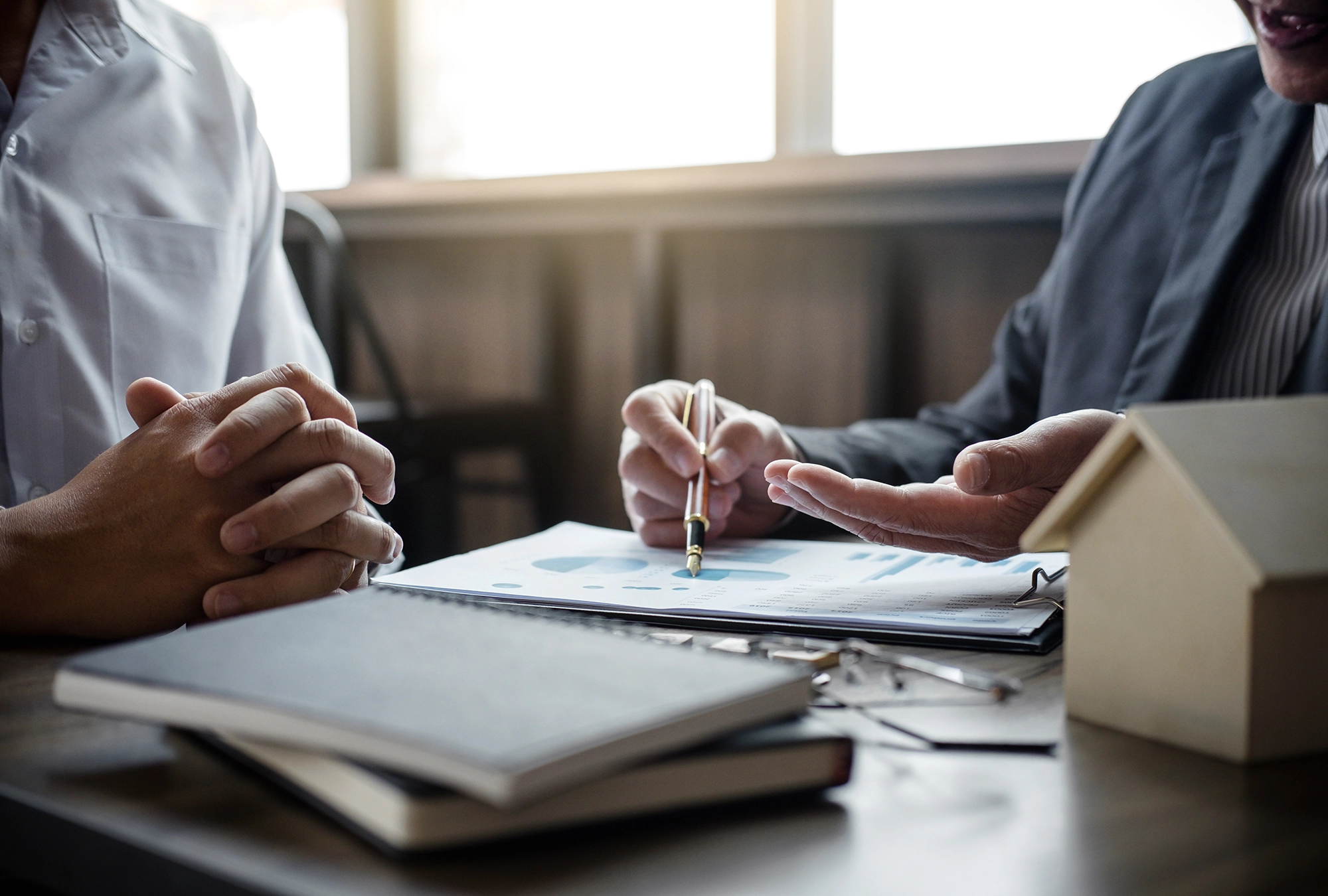 person sitting with an insurance advisor looking at paperwork