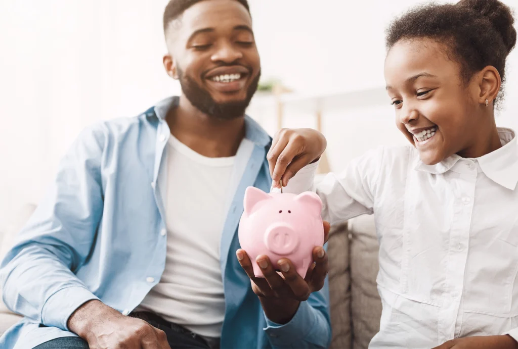 A parent having a conversation about saving with their child