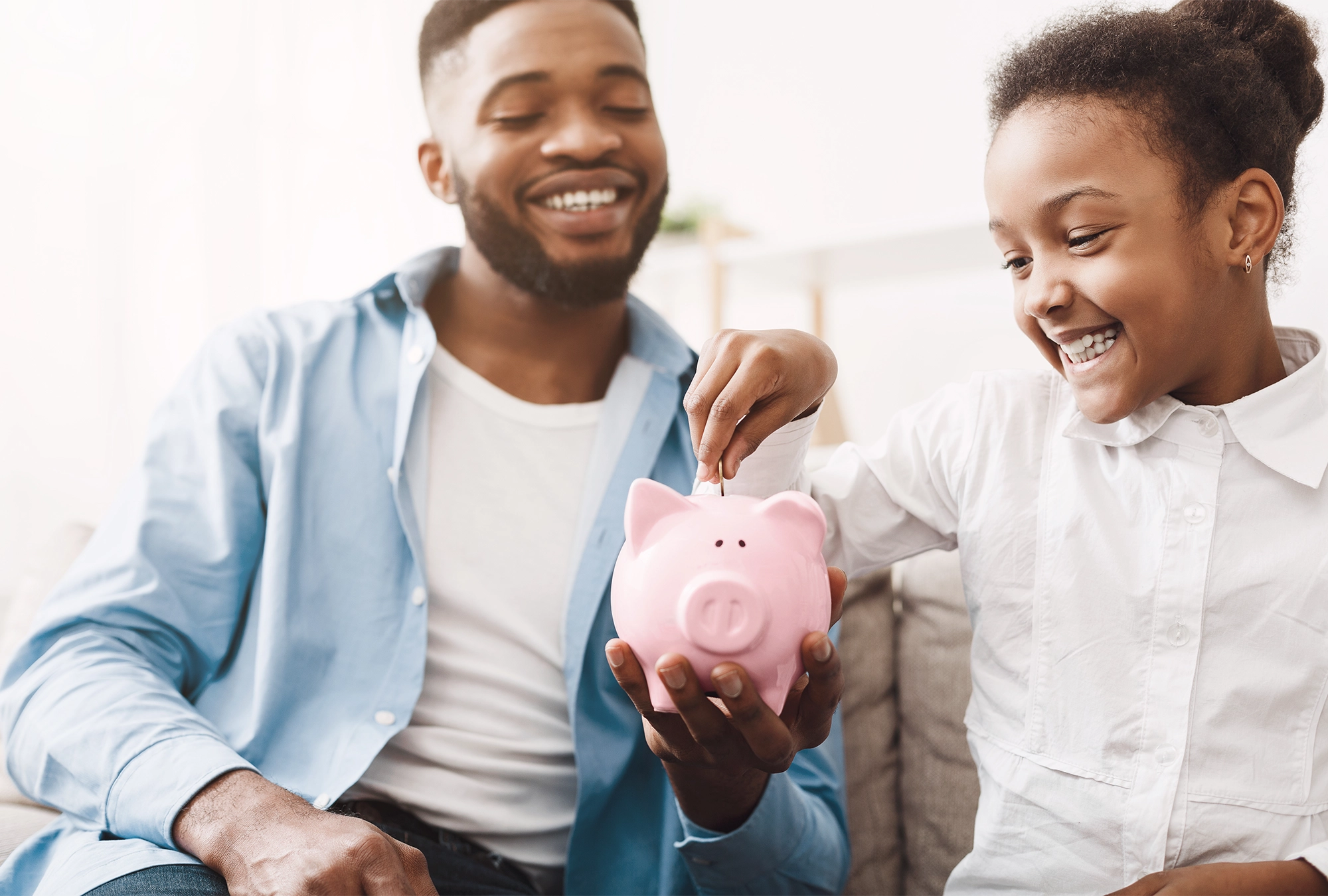 A parent having a conversation about saving with their child