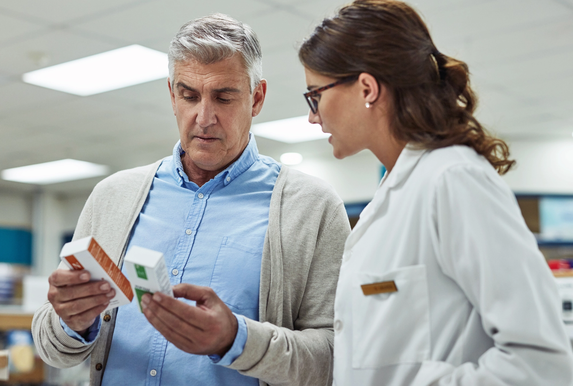 A man talking with his doctor about different medication and their costs