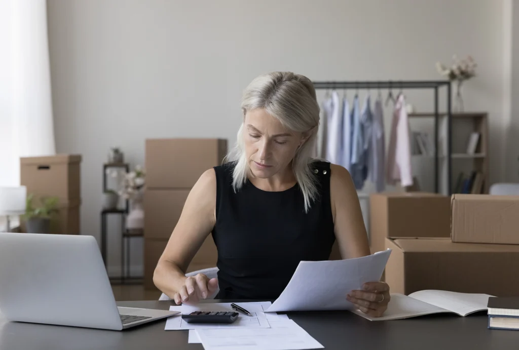 A woman making donations to maximize her charitable tax deduction