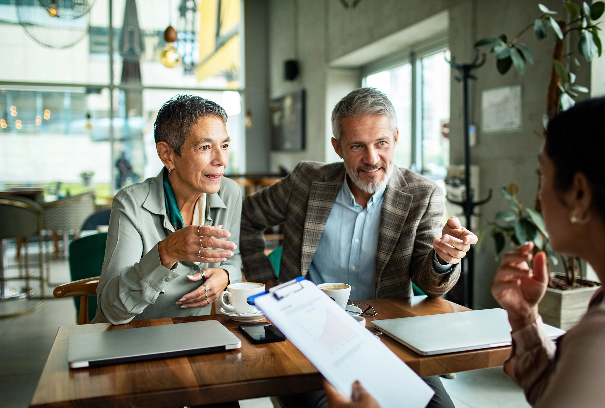 A couple talking with a wealth advisor about mistakes