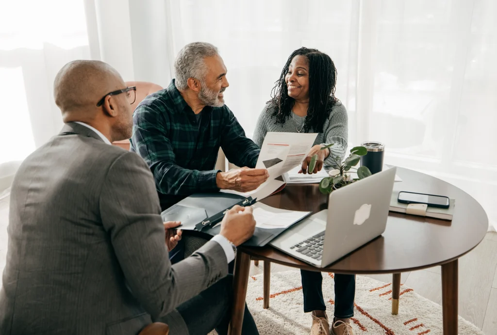 Couple discussing retirement planning with advisor.